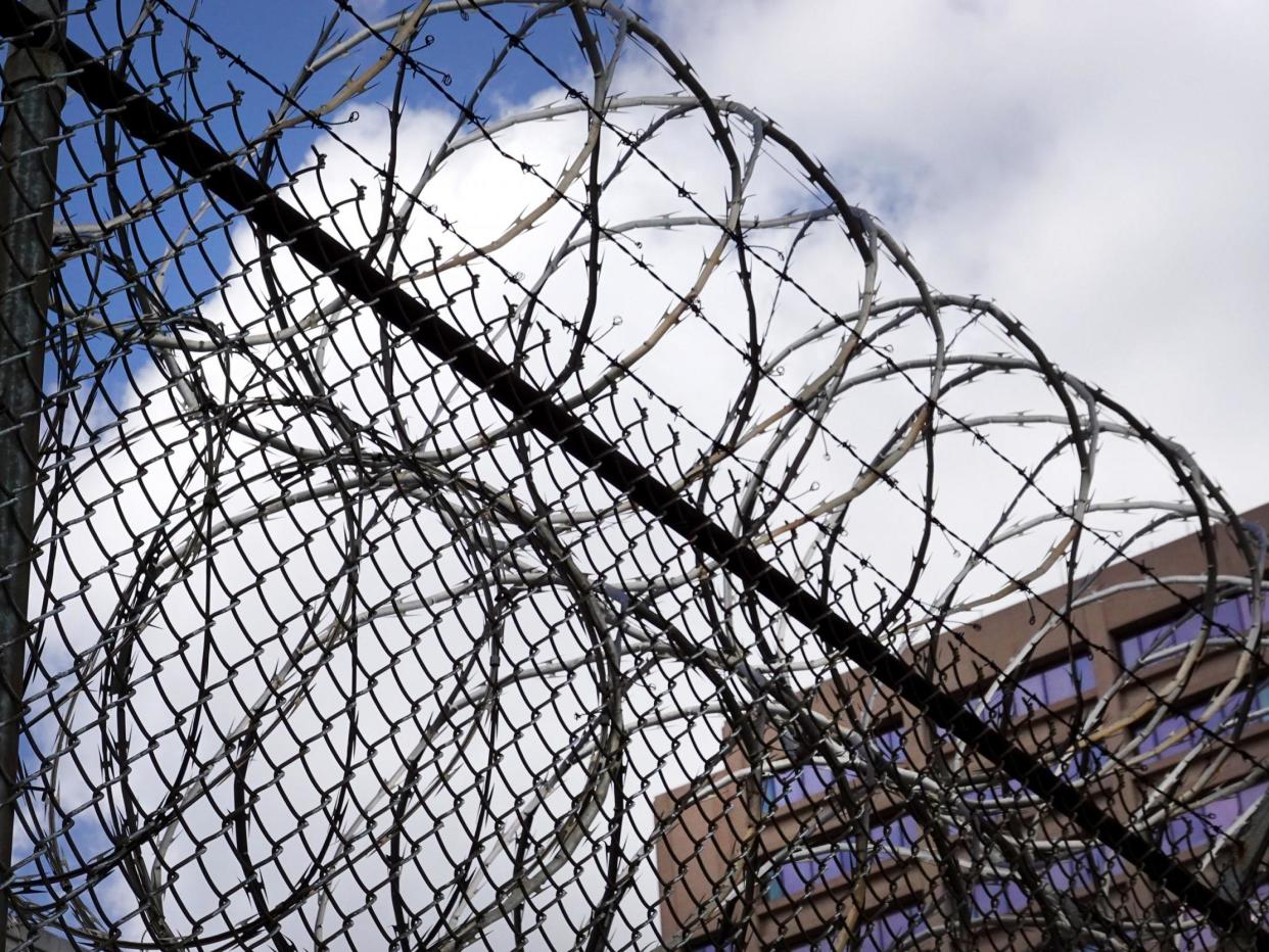 A fence surrounds the Cook County jail complex in Chicago, Illinois: (2020 Getty Images)