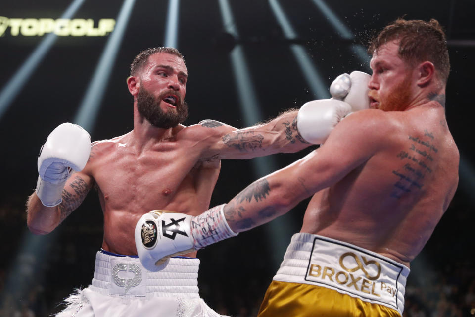 Caleb Plant hits Canelo Alvarez, of Mexico, during a super middleweight title unification fight Saturday, Nov. 6, 2021, in Las Vegas. (AP Photo/Steve Marcus)