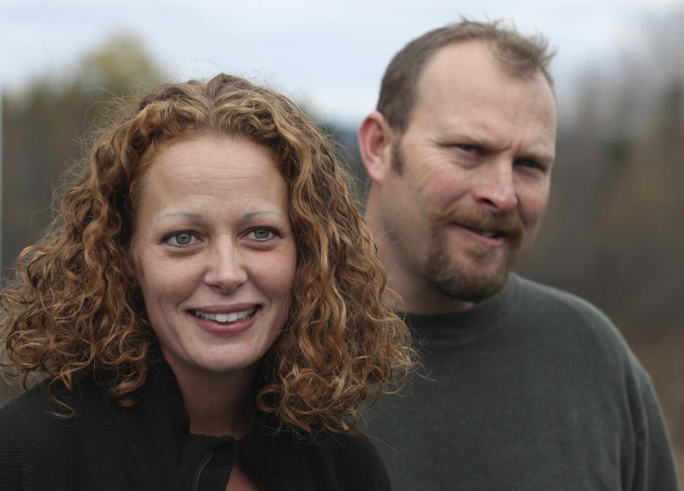 Nurse Kaci Hickox (L) joined by her boyfriend Ted Wilbur, speaks with the media outside of their home in Fort Kent, Maine in this October 31, 2014 file photo. Hickox, who challenged quarantines of health care workers returning from treating West African Ebola patients said November 2, 2014 she thought "an abundance of politics" lurked behind them. (REUTERS/Joel Page)