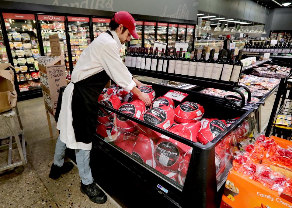 Butcher Randy Thompson stocks turkeys at Sendik's Food Market in Germantown in November 2021.