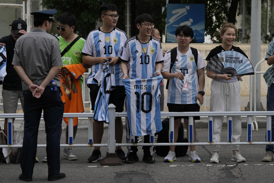 Chinese fans wait to catch a glimpse of the soccer superstar Lionel Messi in Beijing, Tuesday, June 13, 2023. Argentina is scheduled to play Australia in a friendly match in China's capital on Thursday. (AP Photo/Ng Han Guan)