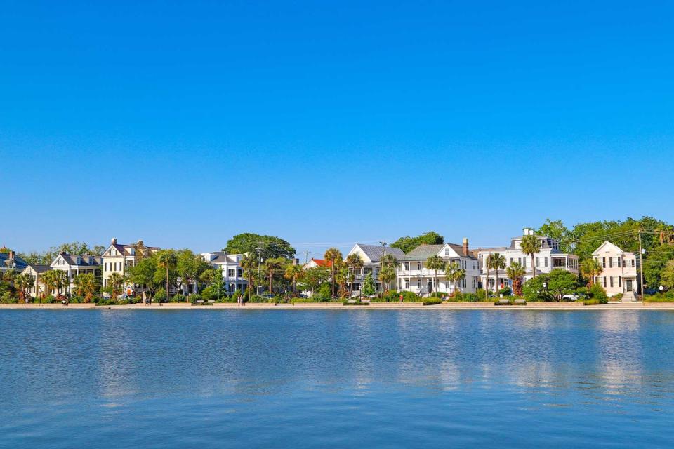 Row of historic homes by Colonial Lake, downtown Charleston, historic district, on a beautiful clear day.