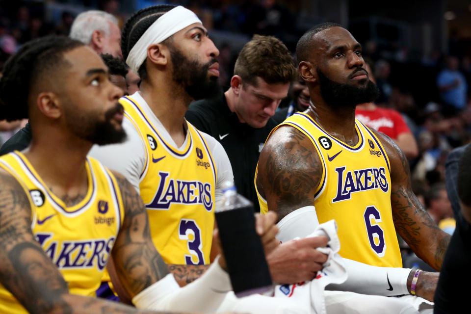 The Lakers&#39; D&#39;Angelo Russell, Anthony Davis and LeBron James sit on the bench during a timeout in Game 2.