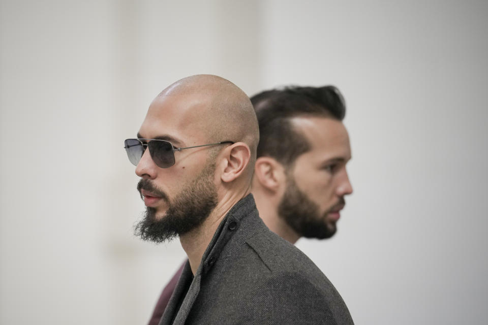 Andrew Tate, left, and his brother Tristan, right, wait inside the Court of Appeals building in Bucharest, Romania, Tuesday, Jan. 30, 2024. (AP Photo/Vadim Ghirda)