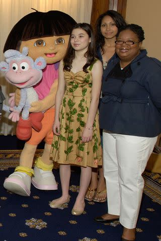 <p>getty</p> Janice Burgess, far right, poses for a photo at a Nickelodeon luncheon