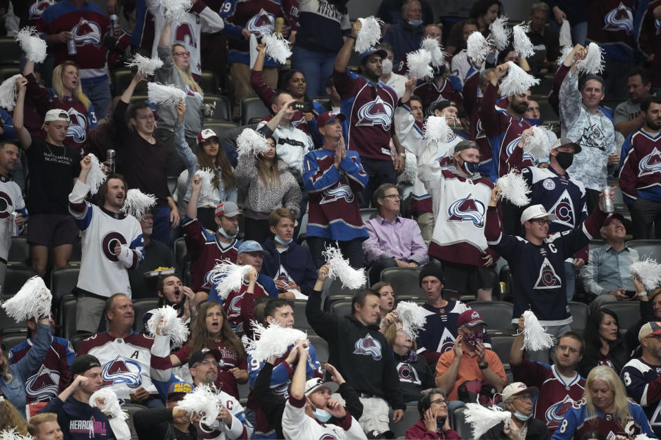 Fans cheer for the Colorado Avalanche in the third period of Game 5 of an NHL hockey Stanley Cup second-round playoff series against the Vegas Golden Knights on Tuesday, June 8, 2021, in Denver. (AP Photo/David Zalubowski)