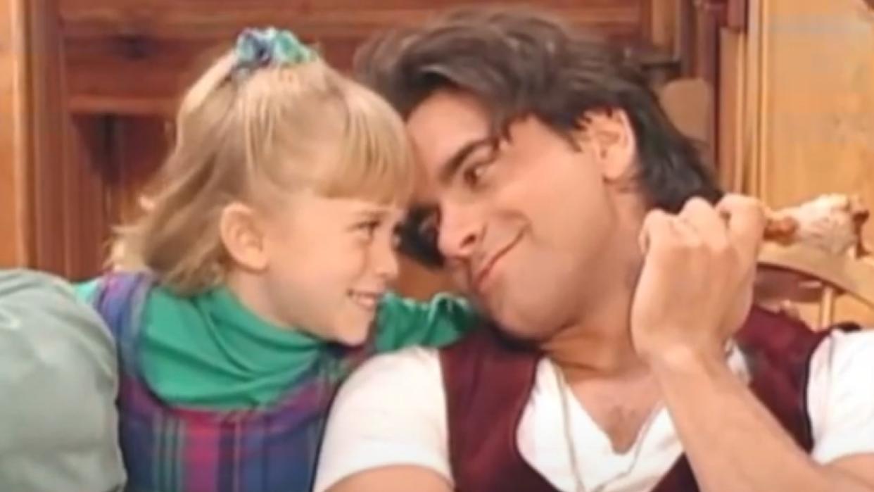  An Olsen twin as Michelle Tanner and John Stamos as Uncle Jesse on Full House. 