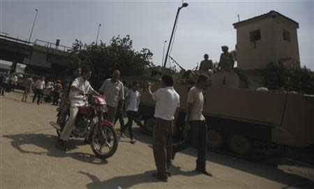 Plainclothes police officers conduct a check on a motorcycle in front of Boulaq Al-Dakrour police station, after an explosion in Giza, south of Cairo, September 2, 2013. REUTERS/Amr Abdallah Dalsh