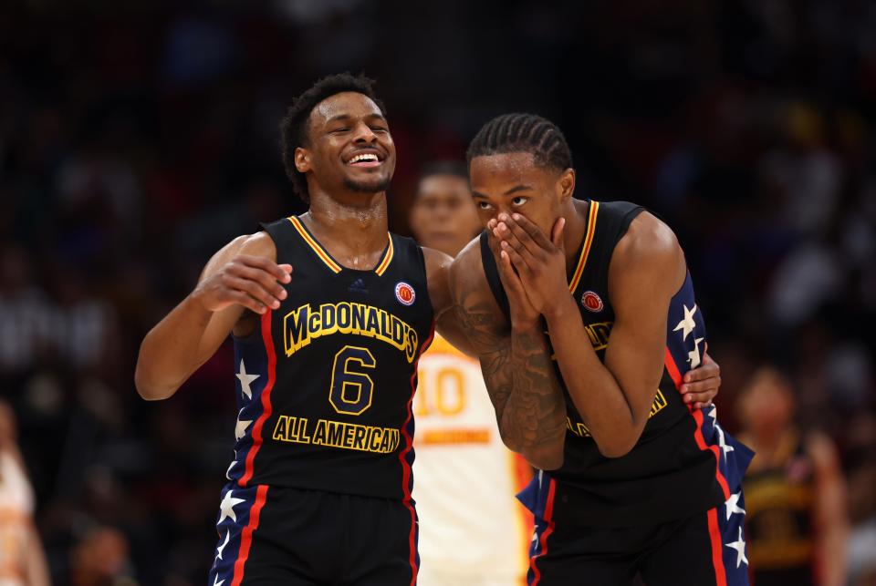 Bronny James, left, has a fun moment with teammate Ron Holland II during the McDonald's All-American game in Houston last year. The Los Angeles Lakers selected James with the 55th overall pick in the draft and he will now be teammates with his father LeBron James.