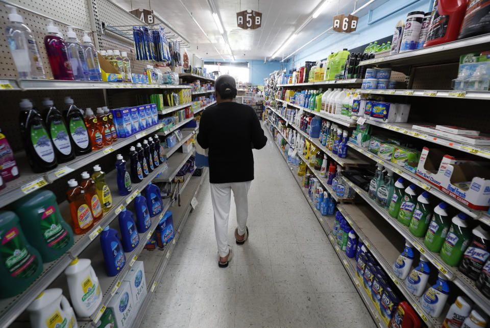 A shopper walks down an isle at a local super market, Friday, May 29, 2020, in Des Moines, Iowa. As if trips to the grocery store weren't nerve-racking enough, shoppers lately have seen the costs of meat, eggs and even potatoes soar as the coronavirus has disrupted processing plants and distribution networks. (AP Photo/Charlie Neibergall)