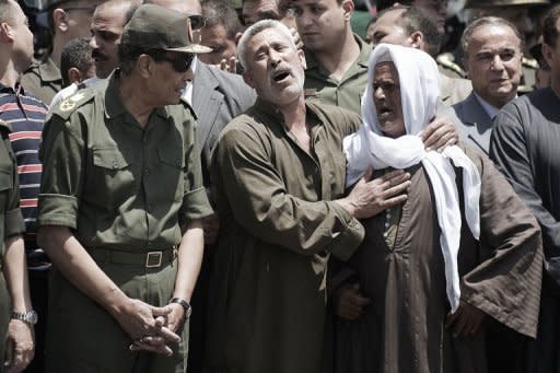 Egypt's military ruler, Field Marshal Hussein Tantawi (left) attends the funeral of a member of Egypt's special forces in Cairo. The soldier was killed in clashes between troops and anti-military protesters on May 4