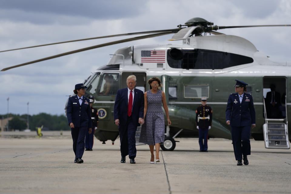 President Donald Trump and first lady Melania Trump walk off Marine One to board Air Force One for a trip to attend the SpaceX Demonstration Mission 2 Launch at Kennedy Space Center, Wednesday, May 27, 2020, in Andrews Air Force Base, Md. (AP Photo/Evan Vucci)