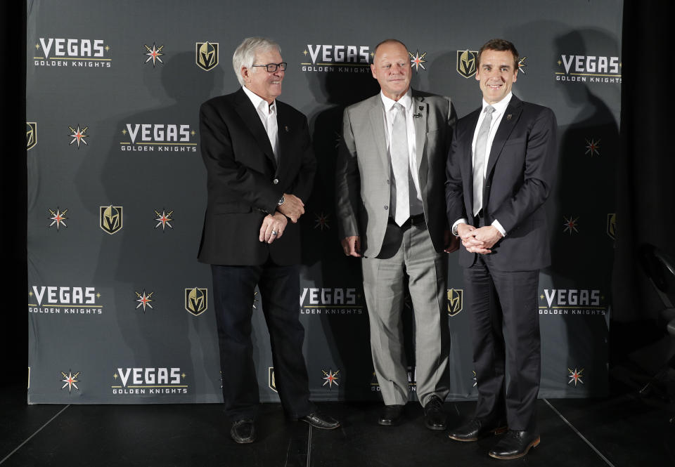 Gerard Gallant, center, poses for photographers with Bill Foley, left, owner of the Vegas Golden Knights, and George McPhee, Vegas Golden Knights general manager, Thursday, April 13, 2017, in Las Vegas. The Vegas Golden Knights have hired Gallant as the first coach of the NHL expansion team. (AP Photo/John Locher)