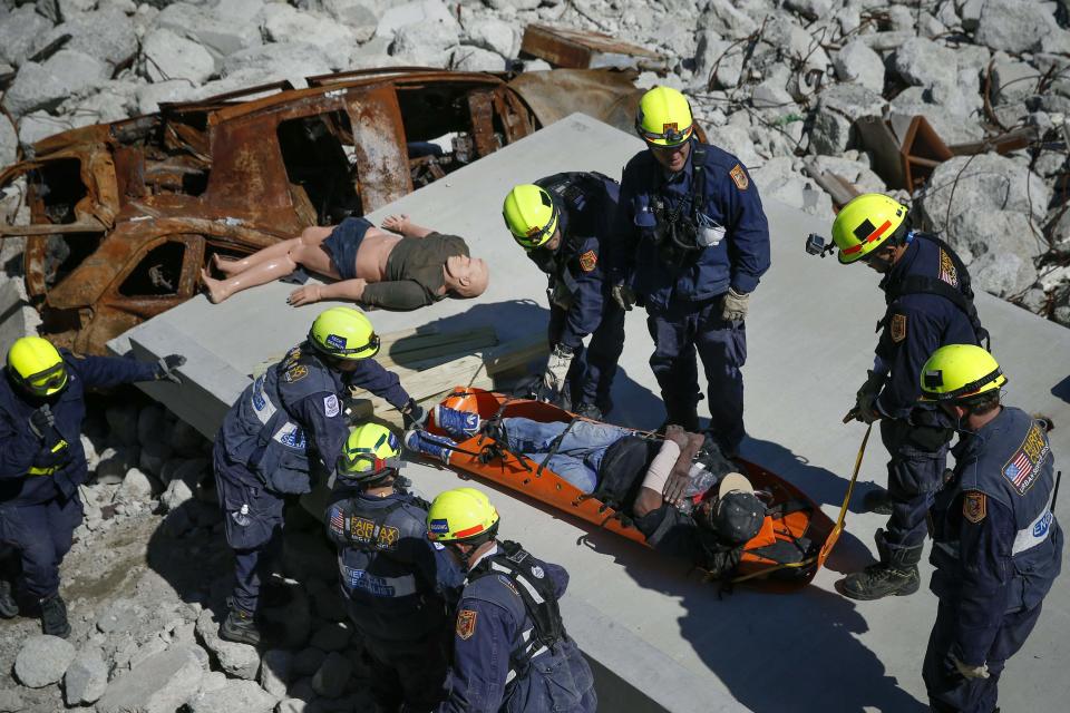 Rescue specialists for USA-1 rescue a victim from the scene of a mock disaster area during a training exercise at the Guardian Center in Perry, Georgia, March 25, 2014. (REUTERS/Shannon Stapleton)