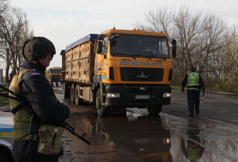 Ukrainian police guard a check-point at the entrance of the southeastern Ukrainian city of Berdyansk on April 19, 2014