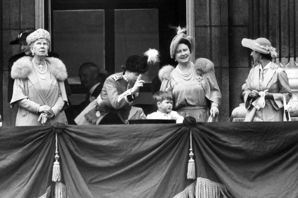 7th June 1951: Princess Elizabeth attempts to get Prince Charles' attention during the jet fighters' fly past to mark the King's birthday. Queen Mary, Queen Elizabeth and Princess Margaret (1930 - 2002) are also on the Buckingham Palace balcony.