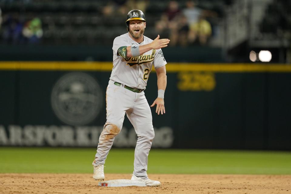 Oakland Athletics' Stephen Vogt (21) stands on second celebrating his run-scoring single in the ninth inning of a baseball game against the Texas Rangers in Arlington, Texas, Wednesday, Sept. 14, 2022. Eric Martins scored on the hit and Vogt advanced to second on the play. (AP Photo/Tony Gutierrez)