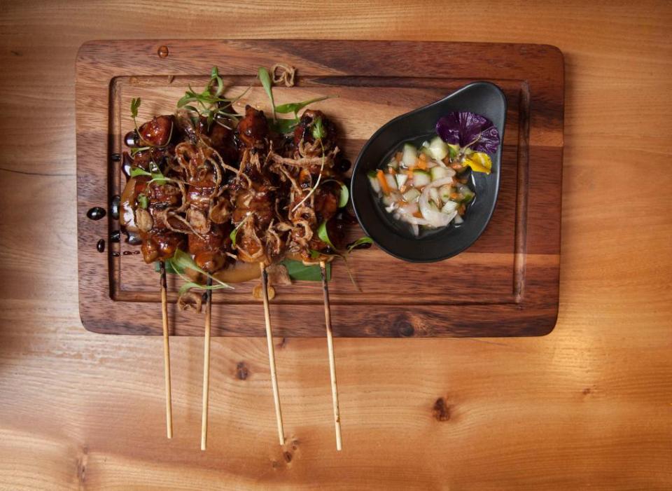 Sate ayam (grilled chicken skewers over charcoal grill, served with homemade peanut sauce) at Toba restaurant, St James, Piccadilly, London.