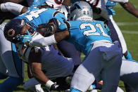 Chicago Bears running back David Montgomery runs the ball while Carolina Panthers outside linebacker Jeremy Chinn (21) moves in to tackle during the second half of an NFL football game in Charlotte, N.C., Sunday, Oct. 18, 2020. (AP Photo/Brian Blanco)