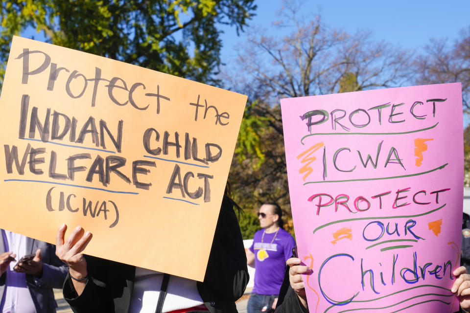 FILE - Demonstrators stand outside the U.S. Supreme Court in Washington, Nov. 9, 2022, as the court hears arguments over the Indian Child Welfare Act. On Thursday, June 15, 2023, the Supreme Court preserved the system that gives preference to Native American families in foster care and adoption proceedings of Native children, leaving in place the 1978 Indian Child Welfare Act that aims to prevent children from being separated from their families to be placed in non-Native homes. (AP Photo/Mariam Zuhaib, File)