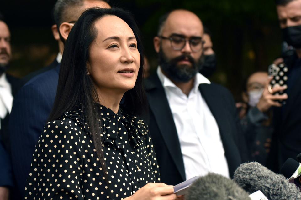 Huawei chief financial officer Meng Wanzhou (C) talks to media at British Columbia Supreme Court after her extradition hearing ended in her favour, in Vancouver British Columbia, Canada on September 24, 2021. - A Canadian judge on Friday ended extradition proceedings against Huawei executive Meng Wanzhou and ordered her bail conditions lifted, effectively freeing her and bringing to a close a nearly three-year legal saga. (Photo by Don MacKinnon / AFP) (Photo by DON MACKINNON/AFP via Getty Images)