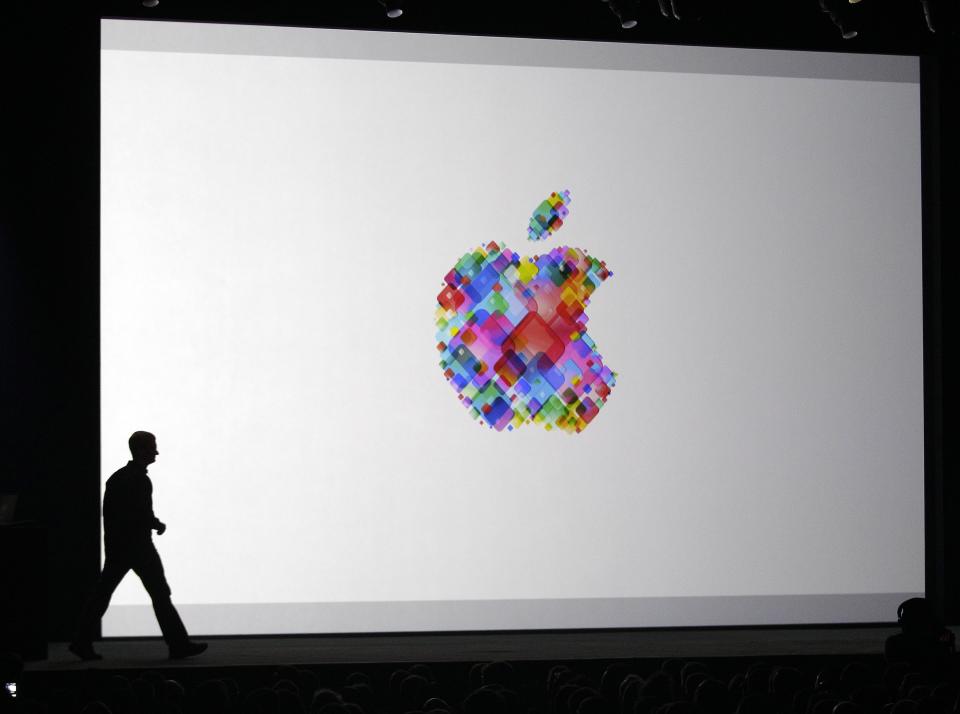 Apple CEO Tim Cook enters the stage during the Apple Developers Conference in San Francisco, Monday, June 11, 2012. Apple says it's introducing a laptop with a super-high resolution "Retina" display, setting a new standard for screen sharpness. The new MacBook Pro will have a 15-inch screen and four times the resolution of previous models, Apple CEO Tim Cook told developers at a conference in San Francisco. (AP Photo/Marcio Jose Sanchez)