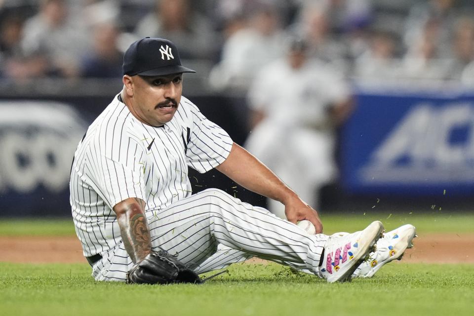 New York Yankees starting pitcher Nestor Cortes attempts to get control of a ball hit back to him by Minnesota Twins' Jose Miranda during the fourth inning of a baseball game Friday, April 14, 2023, in New York. Miranda was safe at first. (AP Photo/Frank Franklin II)