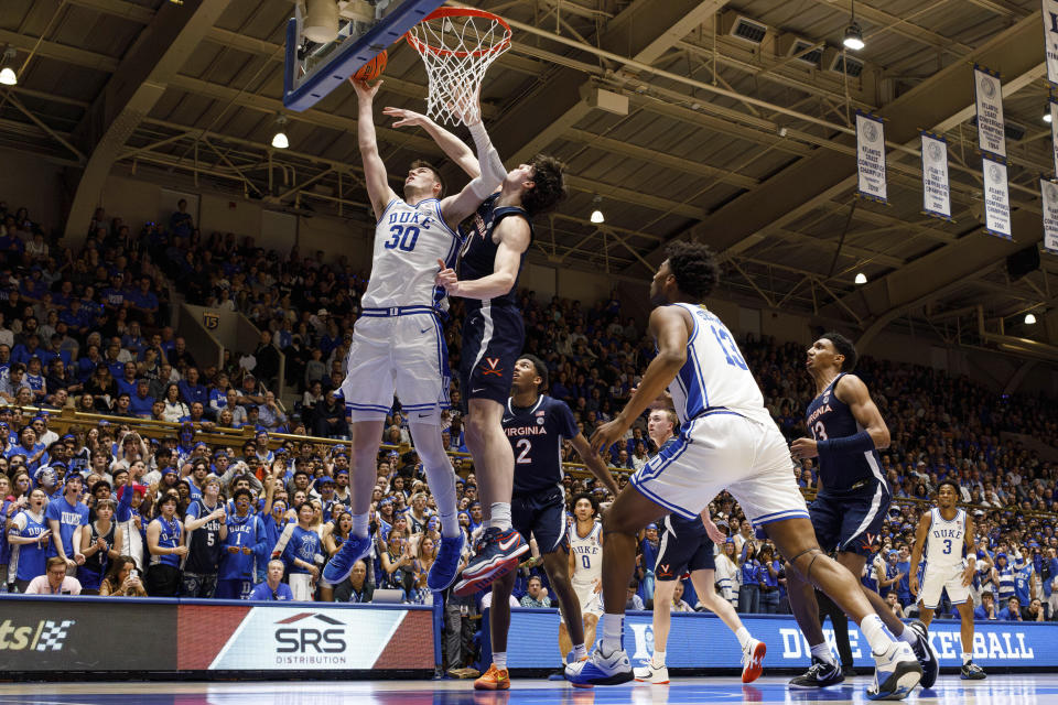 Duke's Kyle Filipowski (30) attempts a shot ahead of Virginia's Blake Buchanan (0) during the second half of an NCAA college basketball game in Durham, N.C., Saturday, Mar. 2, 2024. (AP Photo/Ben McKeown)