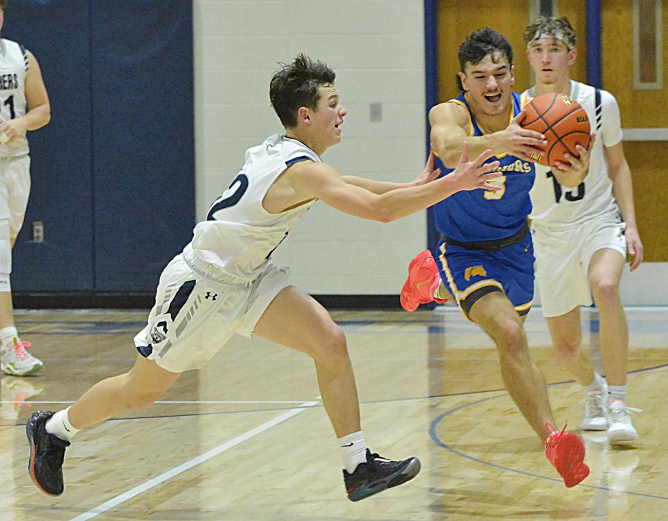 Castlewood's Quincy Thu grabs a loose ball against Great Plains Lutheran's Micah Holien during their high school boys basketball game on Thursday, Jan. 11, 2024 in Watertown. Top-rated Castlewood won 68-38.