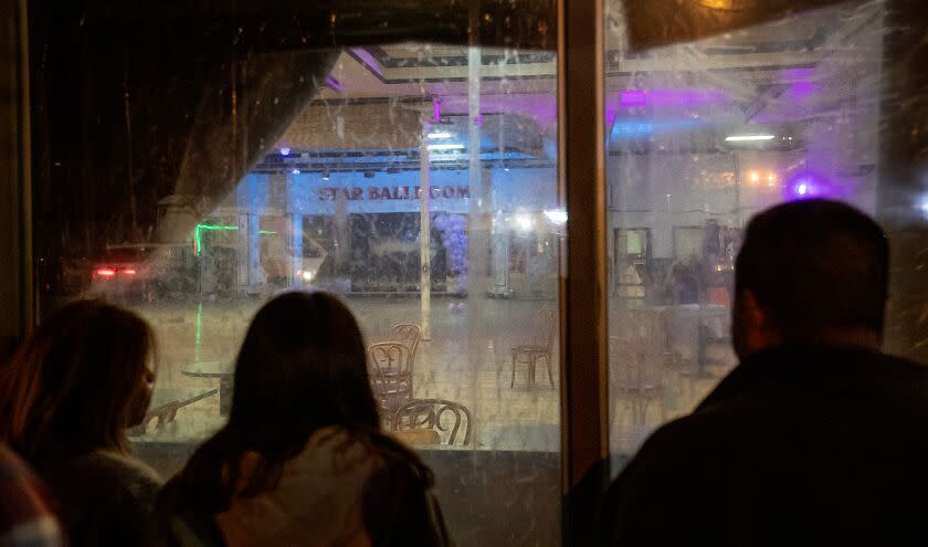 Monterey Park, CA - January 22: After police tape was taken down, curious bystanders view the crime scene inside the Star Dance Studio Ballroom where Huu Can Tran, a 72 year old Asian male, is accused of shooting and killing 10 people and injuring 10 during the Monterey Park mass shooting that took place Saturday night. Photo taken Sunday, Jan. 22, 2023. (Allen J. Schaben / Los Angeles Times)