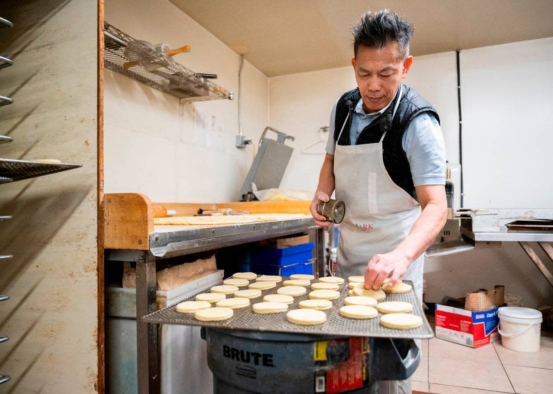 Yam batches, shapes and forms hundreds of doughnuts, largely by hand. This tray of rounds, headed to the proofer, will be filled with jelly or custard after frying.