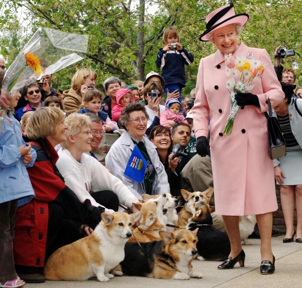 Queen Elizabeth II is greeted by local corgi enthusiasts as she departs the Legislature Building in Edmonton, Alberta Tuesday 23 May 2005, during the state visit to Canada. (PA)