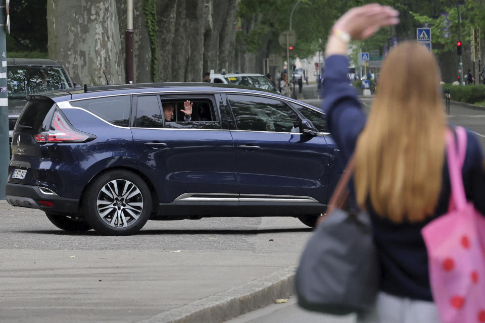 A woman waves to French President Emmanuel Macron as he leaves Annecy, French Alps, after meeting rescue forces Friday, June 9, 2023. A man with a knife stabbed four young children at a lakeside park in the French Alps on Thursday June 8, 2023, assaulting at least one in a stroller repeatedly. Authorities said the children, between 22 months and 3 years old, suffered life-threatening injuries, and two adults were also wounded. (Denis Balibouse/Pool via AP)