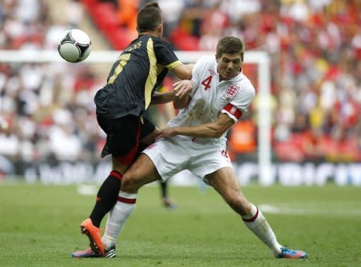 Belgium's Dries Mertens (L) collides with England's Steven Gerrard during their international friendly match at Wembley Stadium in London. England won 1-0