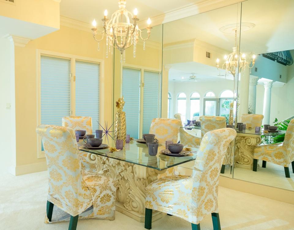 Full floor-to-ceiling mirrors on three walls adds interest to the dining area.