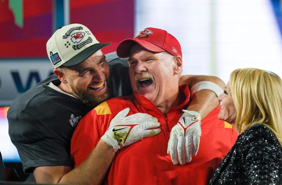 Kansas City Chiefs tight end Travis Kelce (87) hugs Chiefs Head Coach Andy Reid as Tammy Reid looks on after the Chiefs won Super Bowl LVII, defeating the the Philadelphia Eagles, 38-35, on Sunday, Feb. 12, 2023, at State Farm Stadium in Glendale, Arizona.