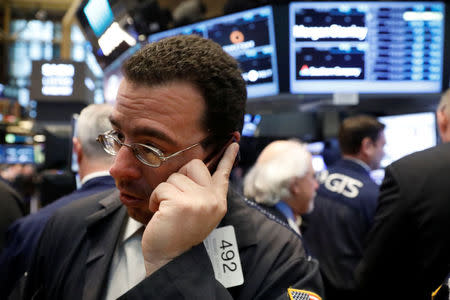 Traders work on the floor of the New York Stock Exchange (NYSE) in New York, U.S., February 22, 2017. REUTERS/Brendan McDermid