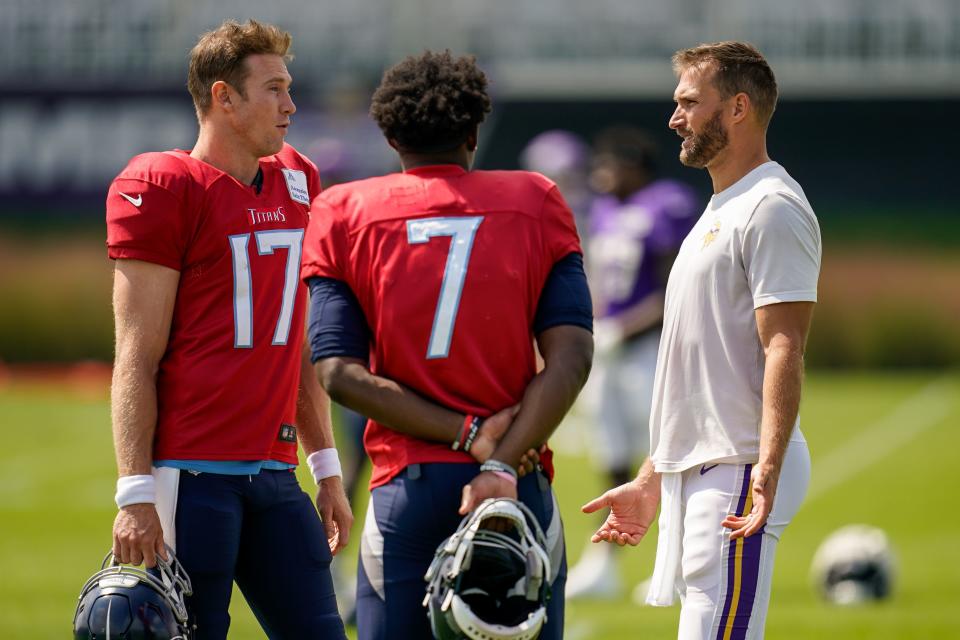 Tennessee Titans quarterback Ryan Tannehill (17) and quarterback Malik Willis (7) chat with Minnesota Vikings quarterback Kirk Cousins (8) after a joint practice in Eagan, Minn., Thursday, Aug. 17, 2023.