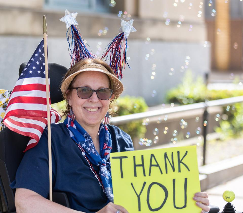 Lynn Pritchard thanks veterans along the route of Canton’s Memorial Day parade in this file photo from 2023.