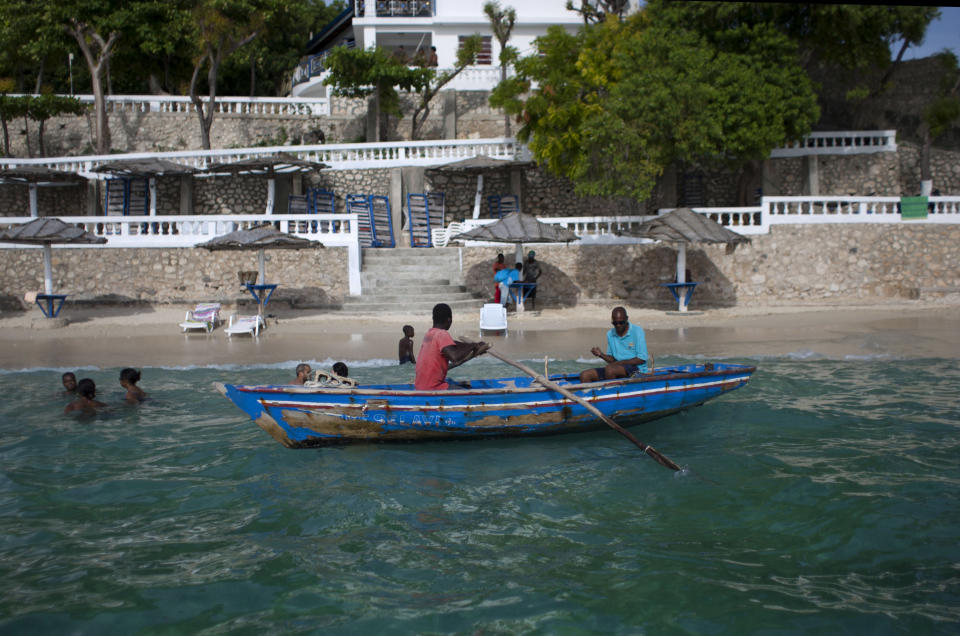 In this June 29, 2013, a water taxi waits for customers at the Wahoo Bay Beach hotel in Montrouis, Haiti. While many in Haiti welcome anything that can create jobs, some critics are questioning the government’s priority of trying to attract high-end tourists at a time when the country faces so many other problems, such as high unemployment, a deadly cholera outbreak and lack of housing for people displaced by the earthquake more than three years ago. (AP Photo/Dieu Nalio Chery)