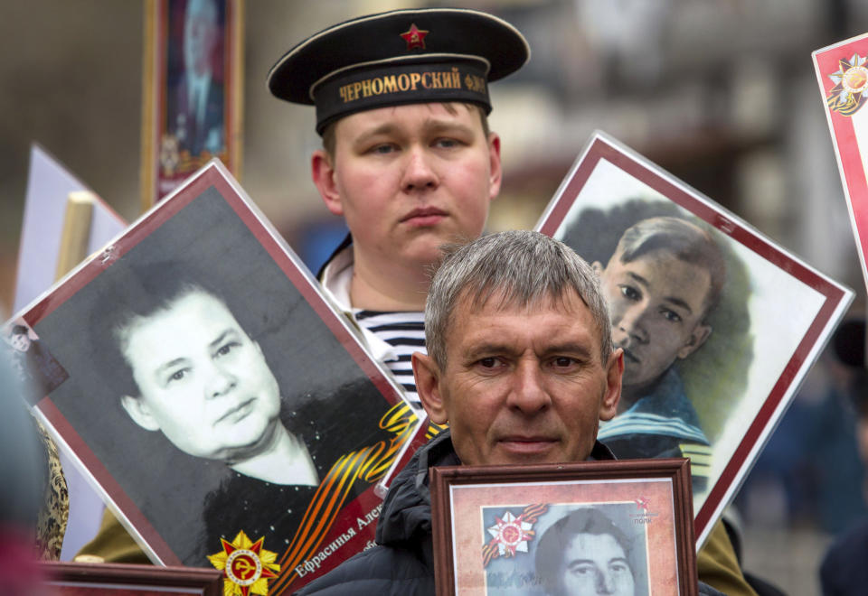 People carry portraits of relatives who fought in World War II, during the Immortal Regiment march in Ulan-Ude, the regional capital of Buryatia, a region near the Russia-Mongolia border, Russia, Monday, May 9, 2022, marking the 77th anniversary of the end of World War II. (AP Photo)