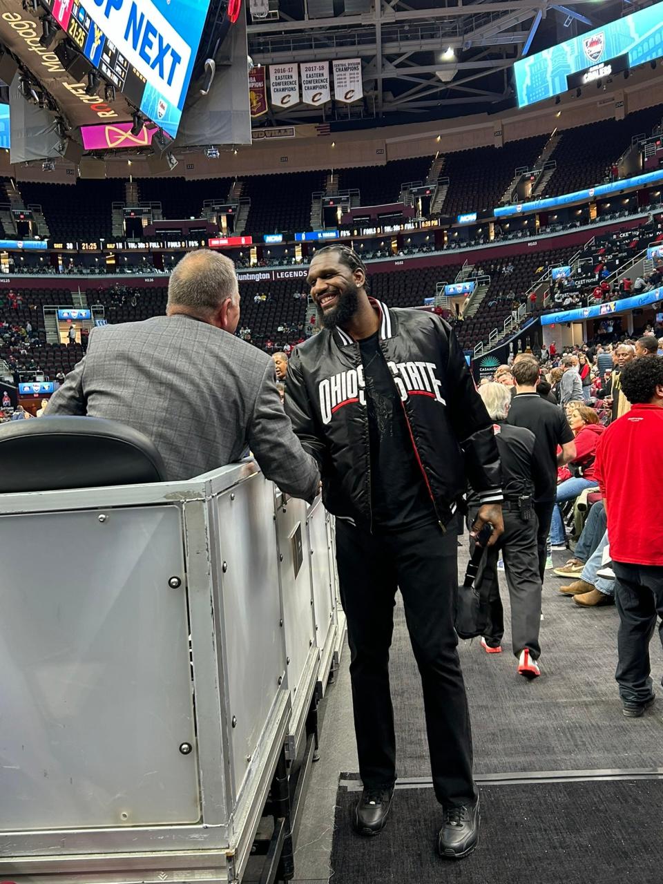 Former Ohio State center Greg Oden shakes hands with a fan while attending a game against West Virginia inside Cleveland's Rocket Mortgage FieldHouse on Dec. 30.