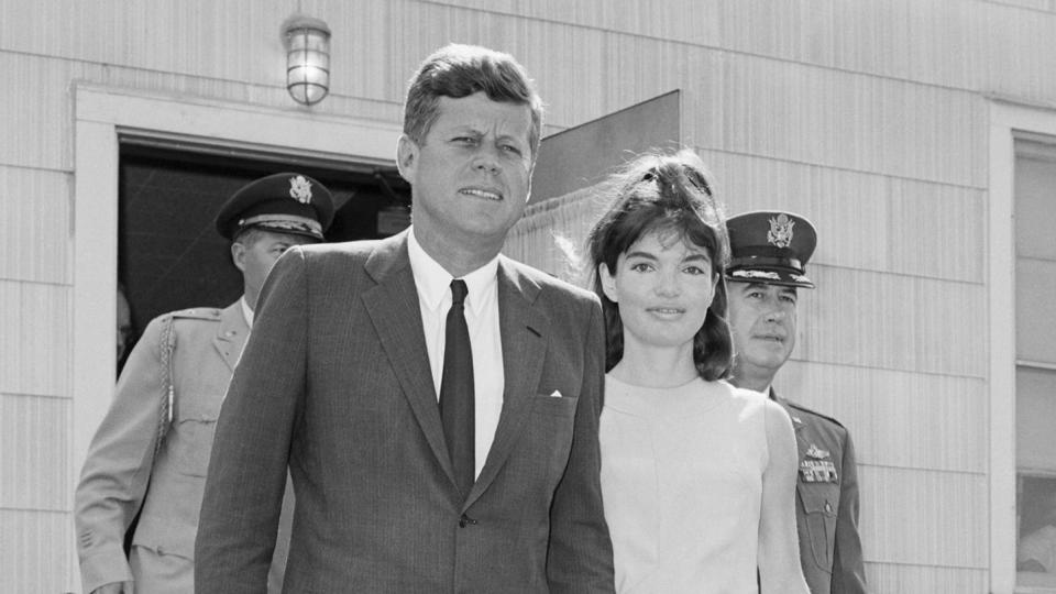 President Kennedy holds hands with his wife Jackie as they leave the Otis Air Force Base hospital on August 14, 1963, where Mrs. Kennedy gave birth on August 7th. The baby boy died after two days. | Location: Otis Air Force Base, Massachusetts, USA.