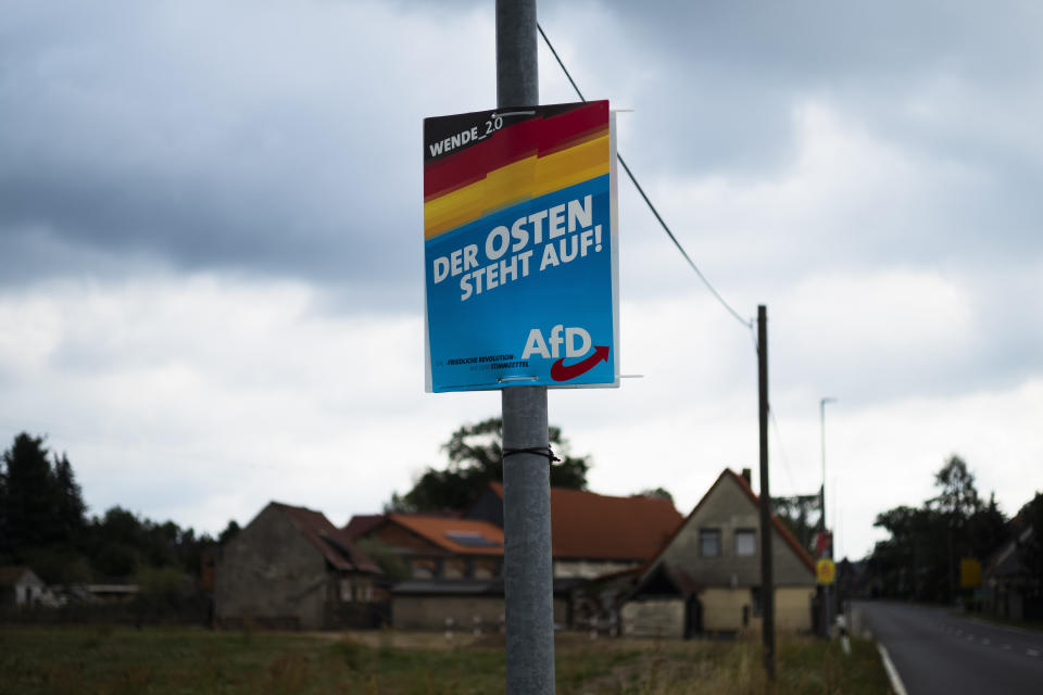 FILE - In this Friday, Aug. 16, 2019 photo an election campaign poster of the far-right Alternative for Germany, or AfD party, for the Saxony state election reading "The East rises up" is displayed in the village of Gruenwald near Bautzen, Germany. Millions of Germans have joined rallies all over the country and even held weekly vigils in their neighborhoods to express their frustration with growing support for far-right populism at the ballot box. (AP Photo/Markus Schreiber, File)