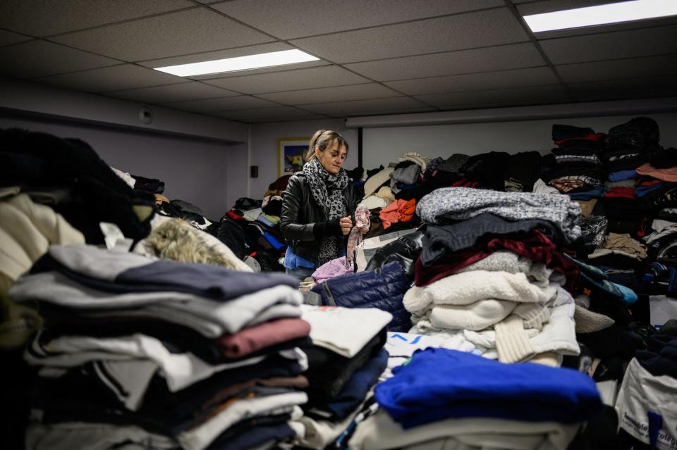 A French volunteer prepares clothing to be sent to Ukrainian people in March 2022. <a href="https://www.gettyimages.com/detail/news-photo/volunteers-prepare-clothes-to-be-sent-to-ukraine-in-the-news-photo/1238895250" rel="nofollow noopener" target="_blank" data-ylk="slk:Jeff Pachoud/AFP via Getty Images;elm:context_link;itc:0;sec:content-canvas" class="link ">Jeff Pachoud/AFP via Getty Images</a>