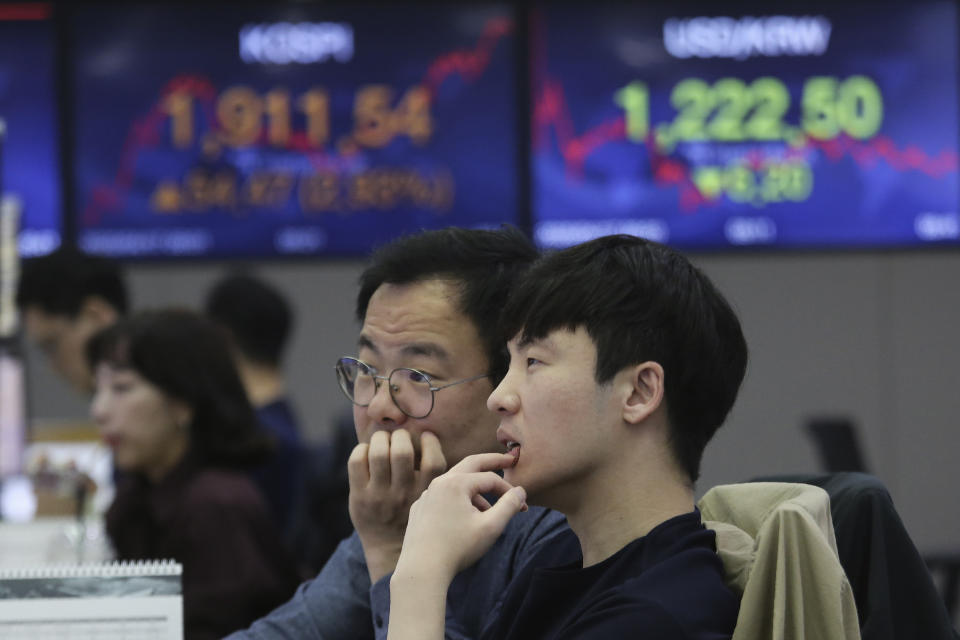 Currency traders watch monitors at the foreign exchange dealing room of the KEB Hana Bank headquarters in Seoul, South Korea, Friday, April 17, 2020. Shares have advanced in Asia after China's economic growth data, while bleak, was better than expected. (AP Photo/Ahn Young-joon)