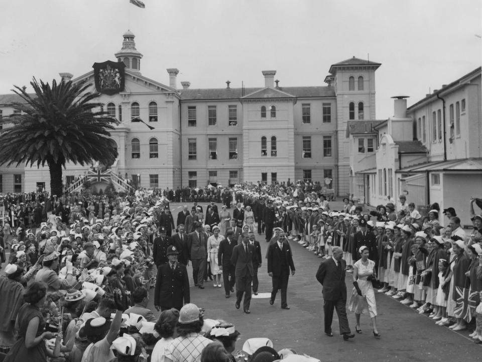 Queen Elizabeth II and Prince Philip are greeted at Auckland Hospital, in Auckland, New Zealand, during the coronation world tour on December 24, 1953.