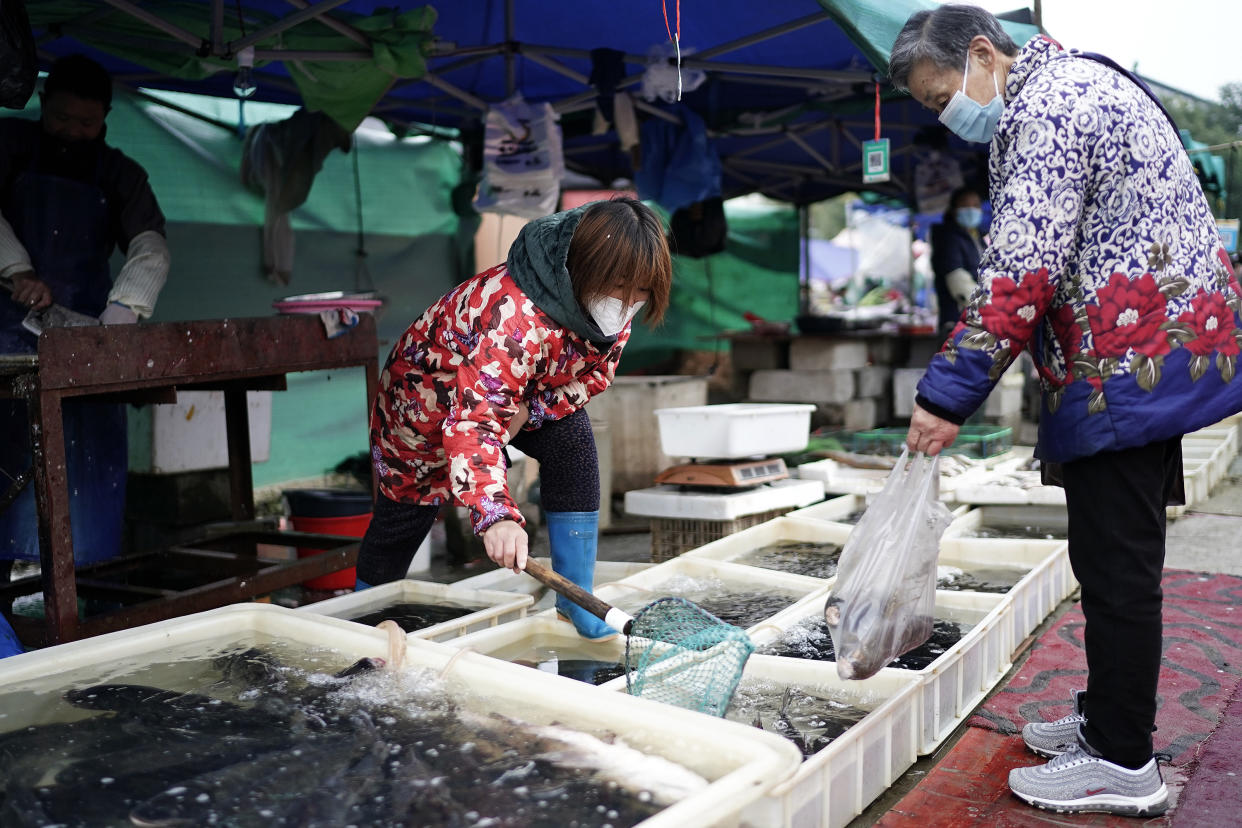 Vendors sell fish in an open market on Dec. 2, 2020, in Wuhan.