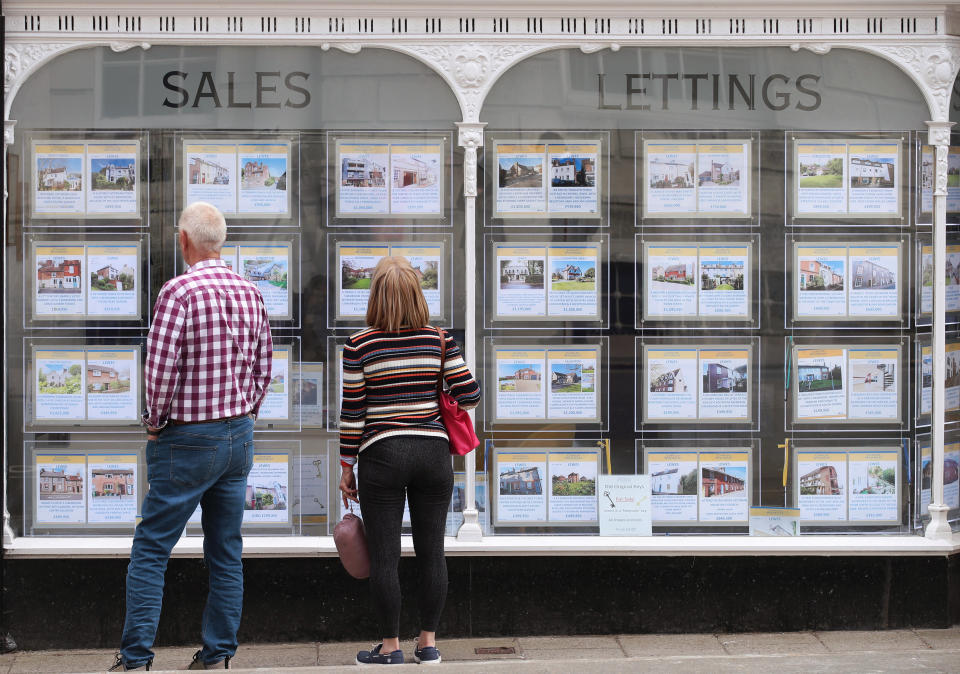 People looking at house price signs displayed in the window of an estate agents in Lewes, East Sussex, as the Office for National Statistics (ONS) has said that the average UK house price has surged by £24,000 during the past year of coronavirus lockdowns. Issue date: Wednesday May 19, 2021. (Photo by Yui Mok/PA Images via Getty Images)