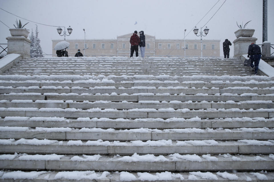 Snow covers the steps of Syntagma square in central Athens, Tuesday, Feb.16, 2021. Unusually heavy snowfall has blanketed central Athens, with authorities warning residents particularly in the Greek capital's northern and eastern suburbs to avoid leaving their homes. (AP Photo/Thanassis Stavrakis)